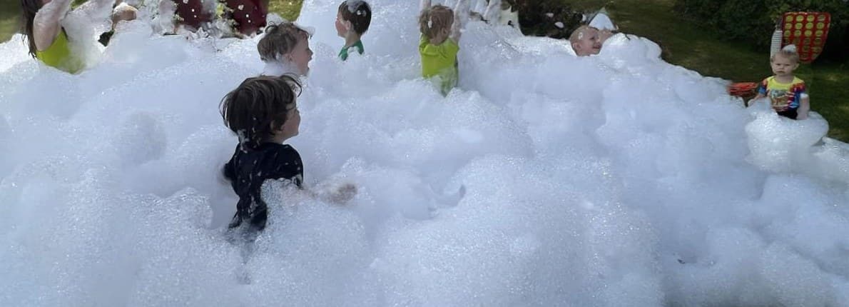 Group of kids enjoying a giant foam party